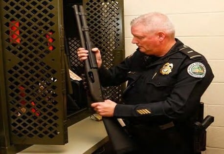officer-checking-in-weapon